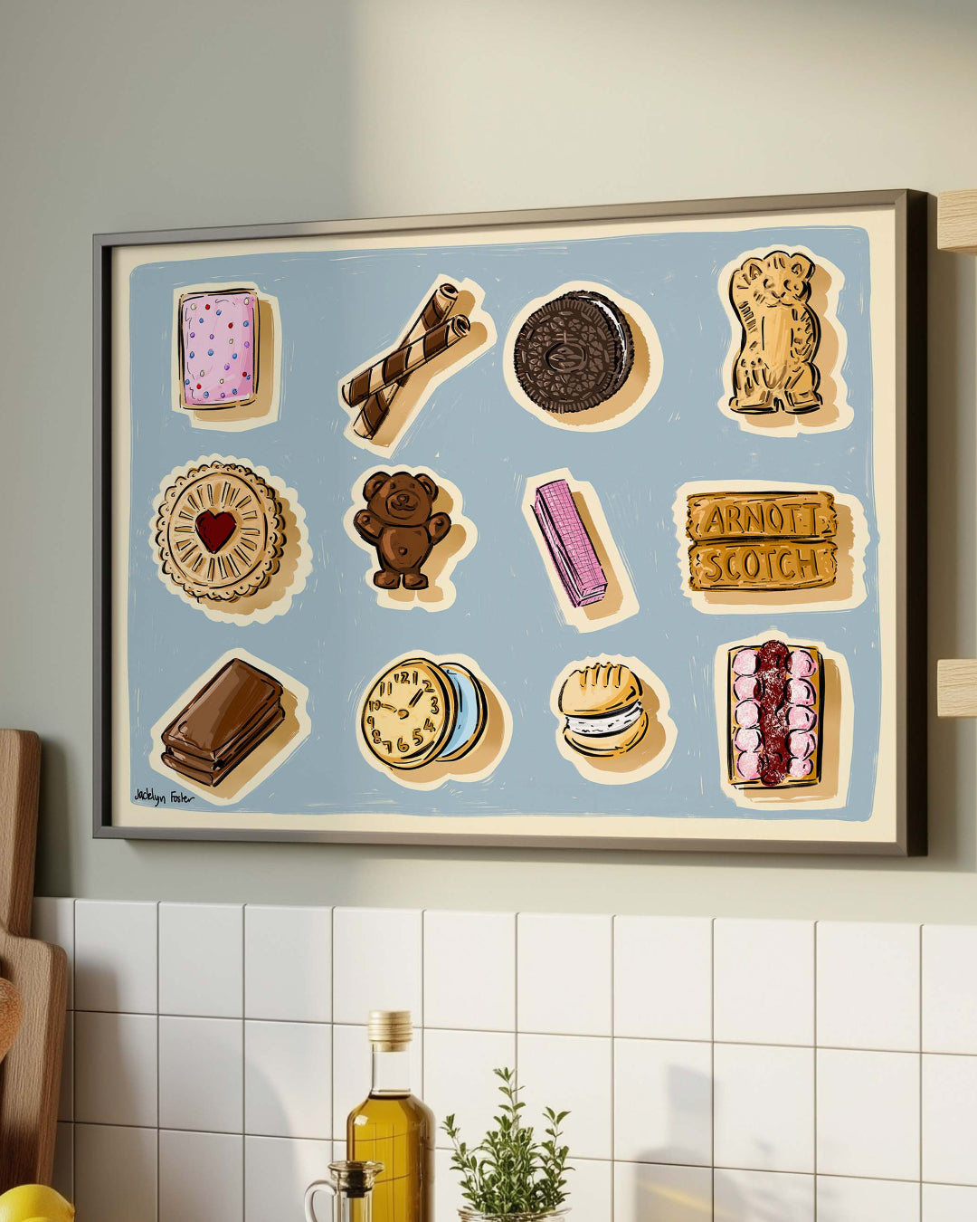 Kitchen counter with a framed artwork of food illustrations, various kitchen items, and a plant.
