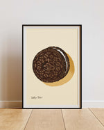 Framed artwork of a chocolate cookie on a beige background